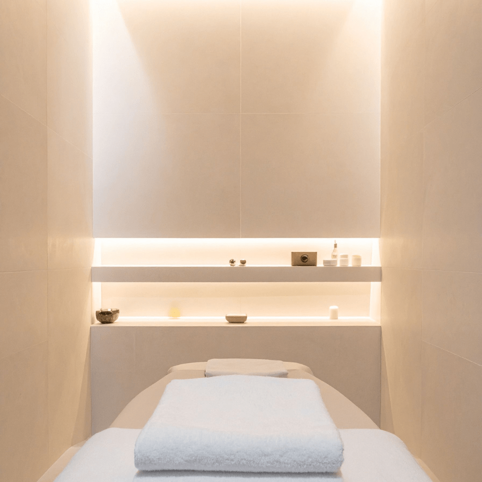 Small facial room idea with minimalist treatment bed and calming lighting
