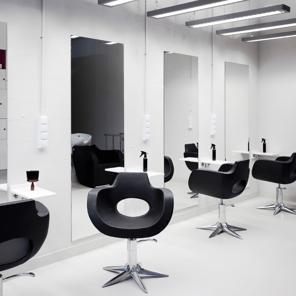 Minimalist low budget beauty salon interior design with black chairs and mirrors